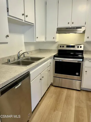 a kitchen with a stove and a sink