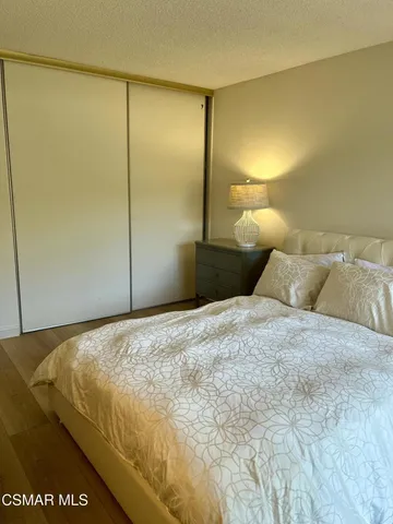 a bedroom with a bed and a mirror