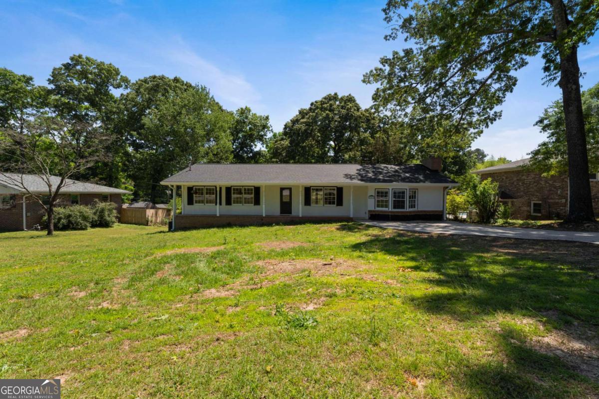 865 Old Tucker Road Stone Mountain, GA 30087 - Photo 3 of 57 a front view of a house with a garden