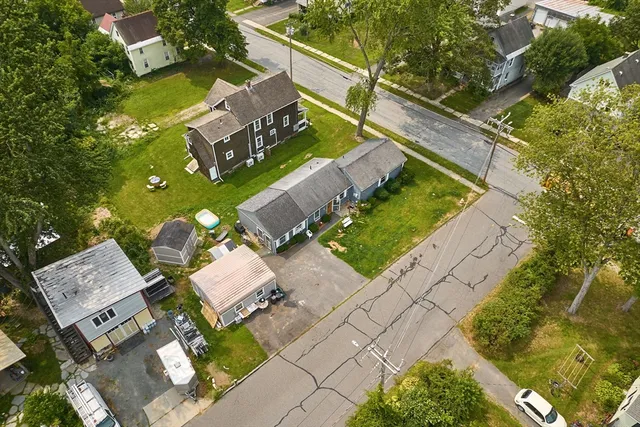 an aerial view of a house with a yard