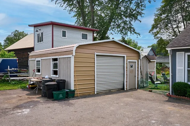 a front view of a house with cars parked