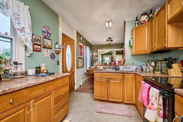 a kitchen with stainless steel appliances granite countertop a stove a sink dishwasher and cabinets with wooden floor