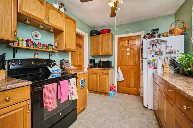 a kitchen with stainless steel appliances granite countertop a refrigerator a stove and a sink