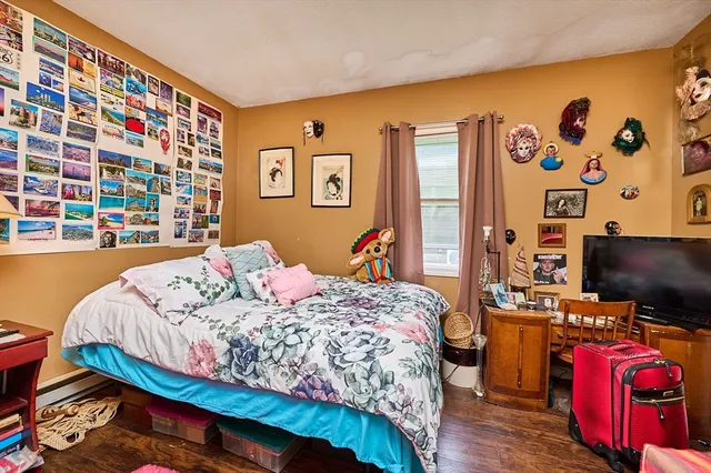 a bedroom with a bed and a flat screen tv