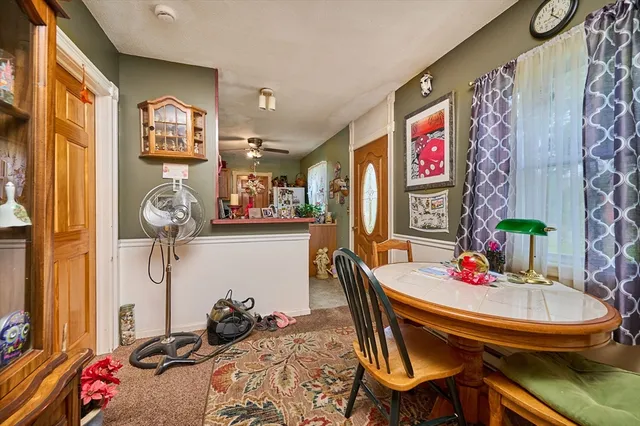 a room with a table chairs and entryway