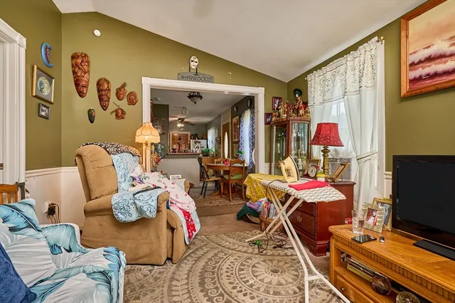 a living room filled with furniture and a flat screen tv