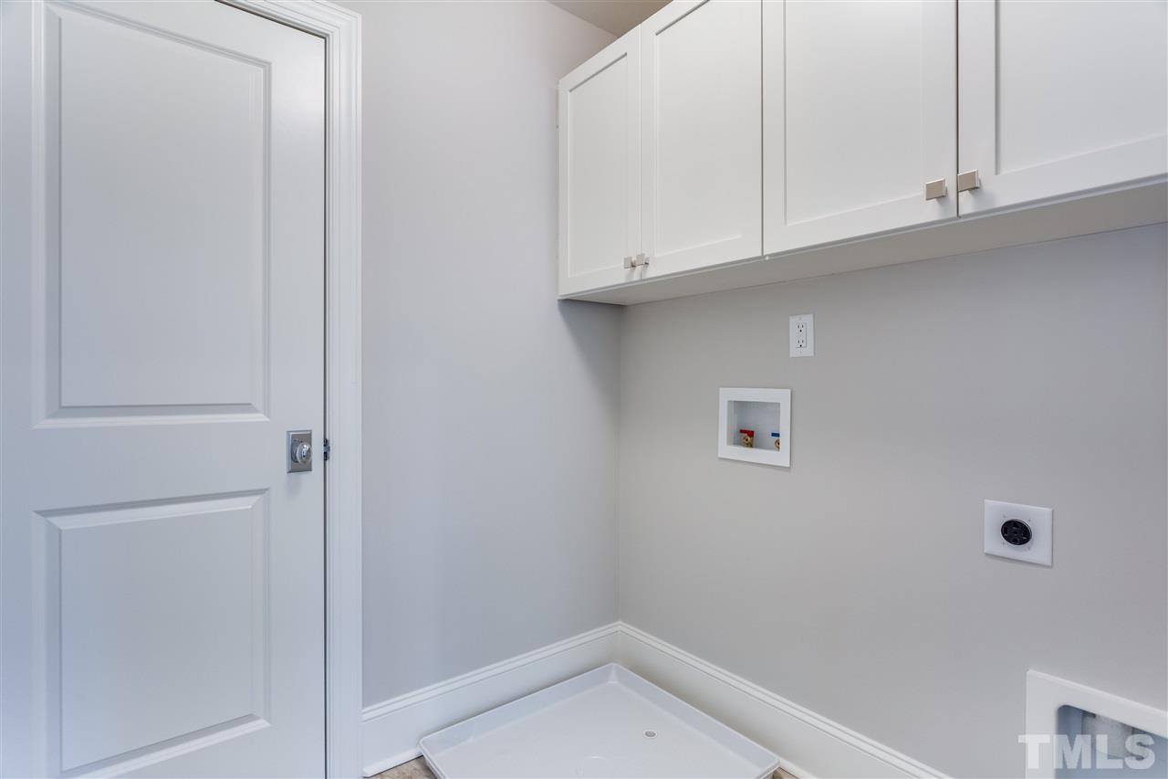 1307 Filmore Street Raleigh, NC 27605 - Photo 18 of 24 Walk-in Laundry Room with custom cabinets & tile floor
