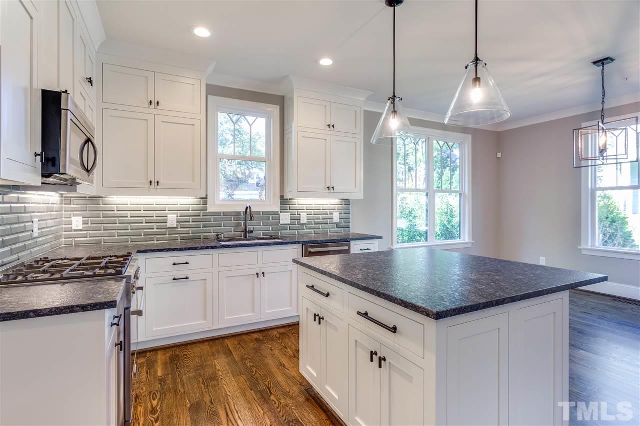 1307 Filmore Street Raleigh, NC 27605 - Photo 5 of 24 Bertazzoni Appliances, custom double-stacked cabinets, island, leathered countertops, tile backsplash with under-cab lights & large pantry.
