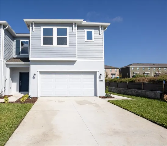 a front view of a house with a yard and garage