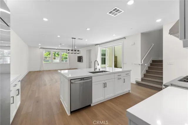 a kitchen with stove cabinets and wooden floor