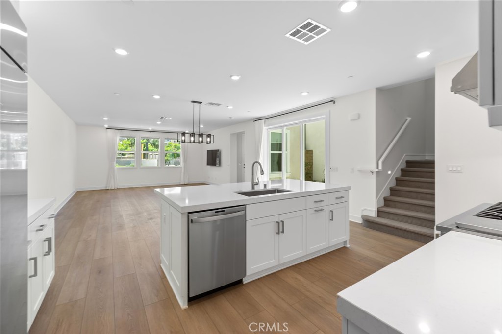156 Chorus Irvine, CA 92618 - Photo 11 of 45 a kitchen with stove cabinets and wooden floor