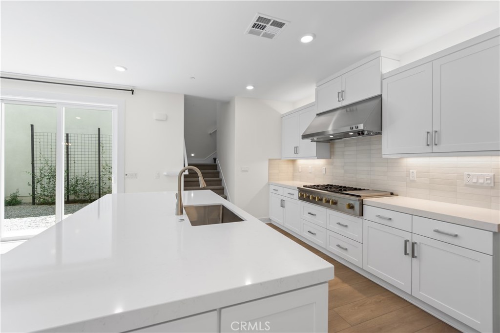 156 Chorus Irvine, CA 92618 - Photo 12 of 45 a kitchen with granite countertop a sink stainless steel appliances and cabinets