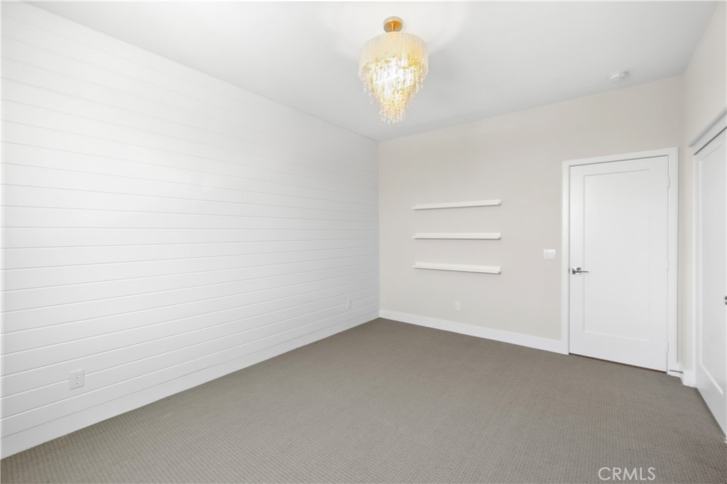 156 Chorus Irvine, CA 92618 - Photo 17 of 45 an empty room with a chandelier