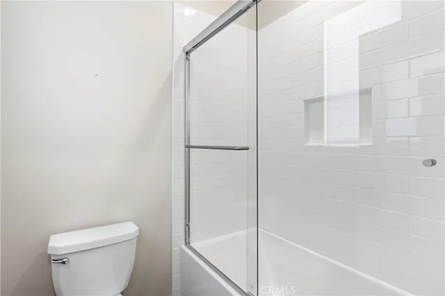 a bathroom with a shower and a toilet