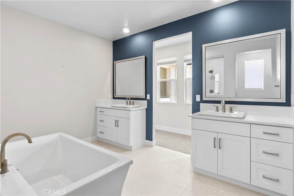 156 Chorus Irvine, CA 92618 - Photo 22 of 45 a bathroom with a bathtub sink and mirror