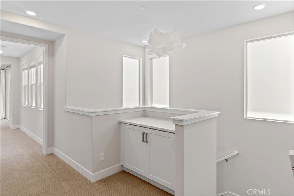 156 Chorus Irvine, CA 92618 - Photo 28 of 45 a view of a kitchen with white cabinets and a window