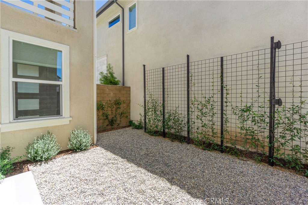 156 Chorus Irvine, CA 92618 - Photo 36 of 45 a view of a brick house with floor to ceiling windows