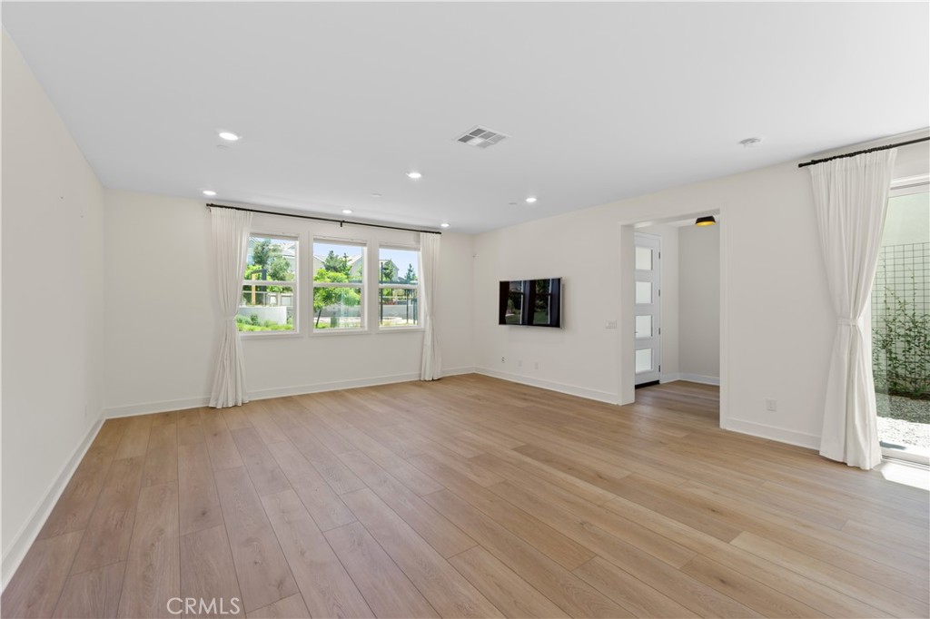 156 Chorus Irvine, CA 92618 - Photo 6 of 45 an empty room with wooden floor and window