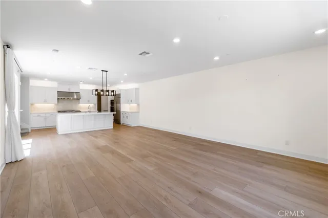 a view of a kitchen with a sink and a stove top oven