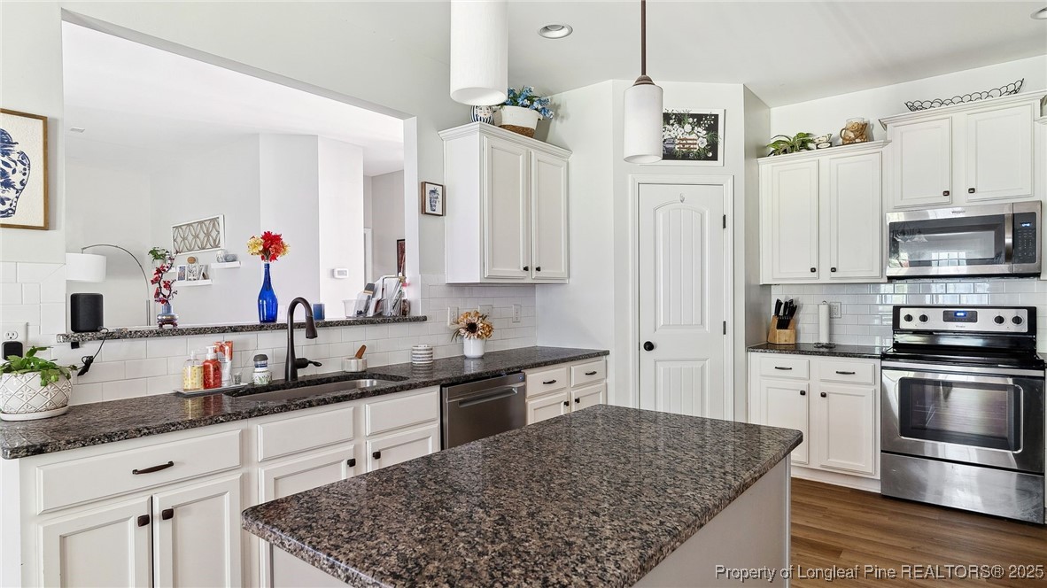 75 Bynum Court Carthage, NC 28327 - Photo 14 of 49 a kitchen with stainless steel appliances granite countertop a sink stove and refrigerator