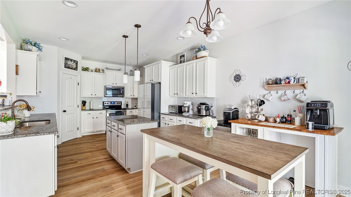75 Bynum Court Carthage, NC 28327 - Photo 17 of 49 a kitchen with stainless steel appliances granite countertop a sink refrigerator and cabinets