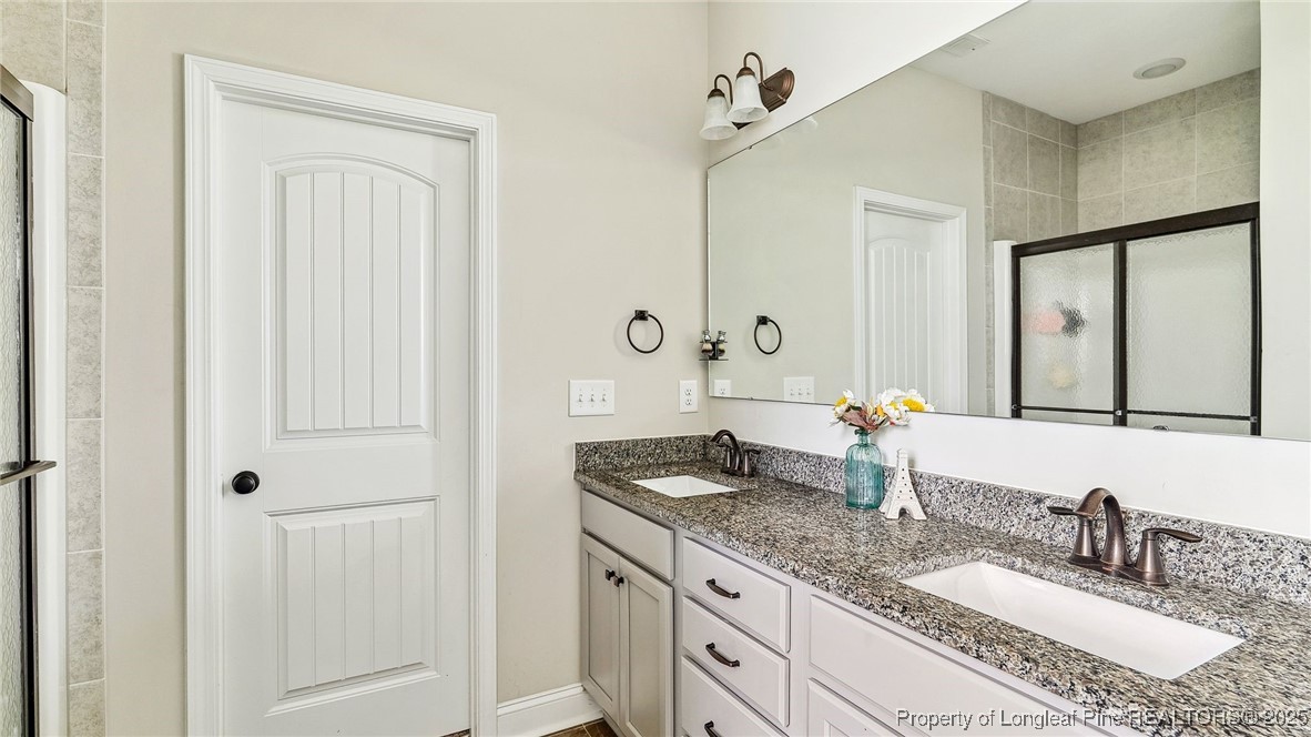 75 Bynum Court Carthage, NC 28327 - Photo 23 of 49 a bathroom with a granite countertop sink and a mirror