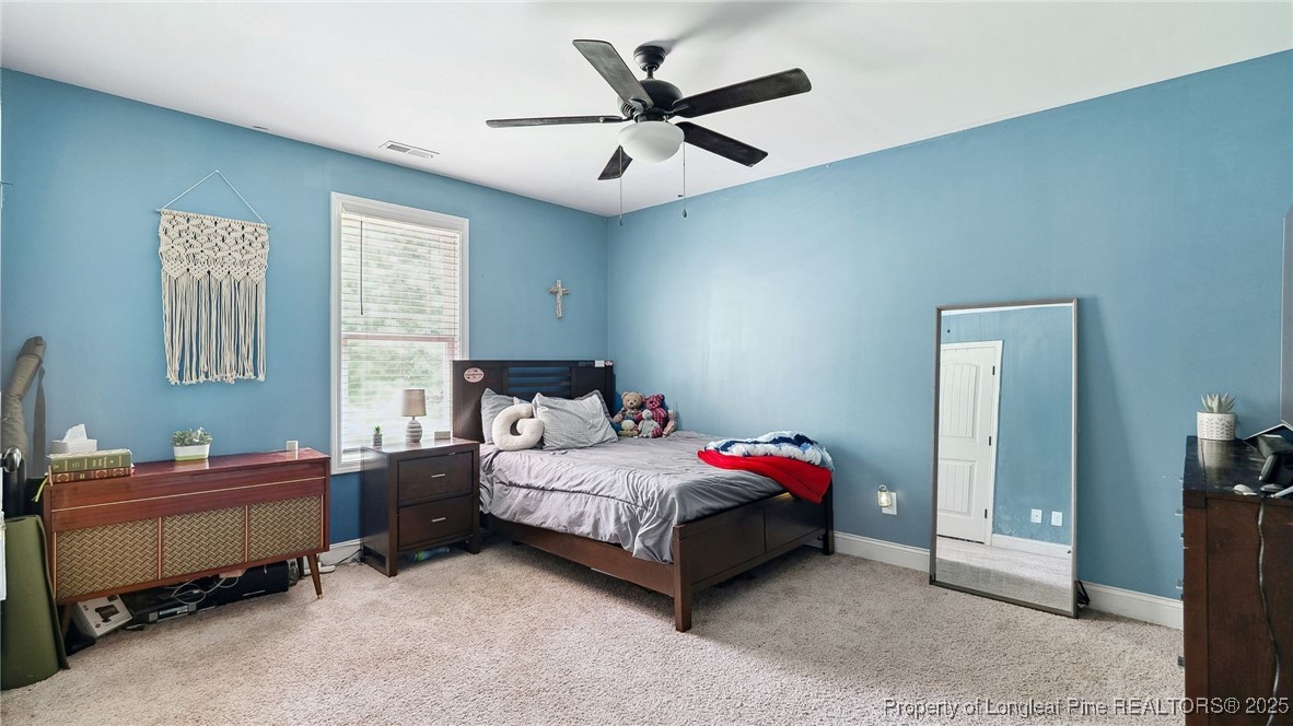 75 Bynum Court Carthage, NC 28327 - Photo 24 of 49 a bedroom with a bed and a ceiling fan