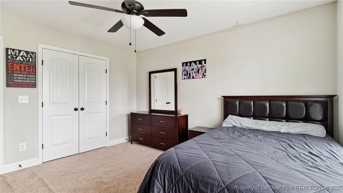 75 Bynum Court Carthage, NC 28327 - Photo 27 of 49 a bedroom with a bed and a chandelier