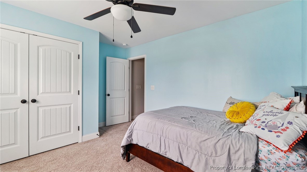 75 Bynum Court Carthage, NC 28327 - Photo 30 of 49 a bedroom with a bed and a chandelier