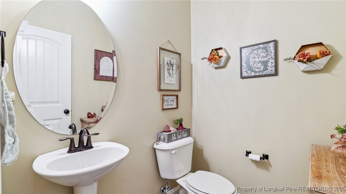 75 Bynum Court Carthage, NC 28327 - Photo 35 of 49 a bathroom with a toilet a sink and a mirror