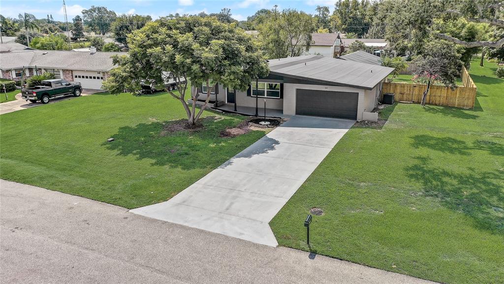 a view of a house with a backyard