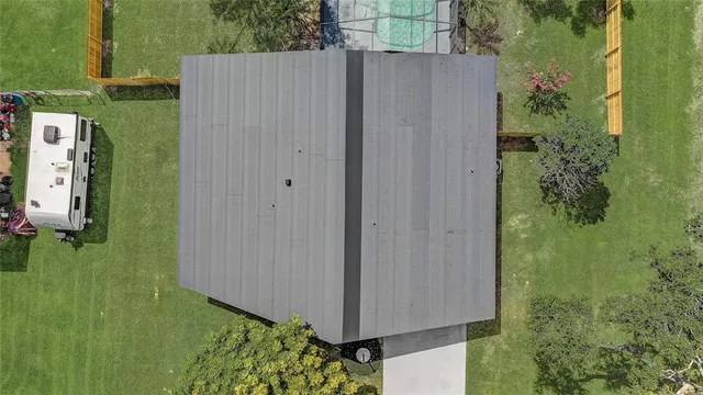 a front view of a house with a garden and trees