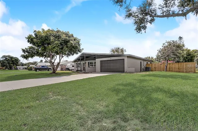 a front view of house with yard and green space