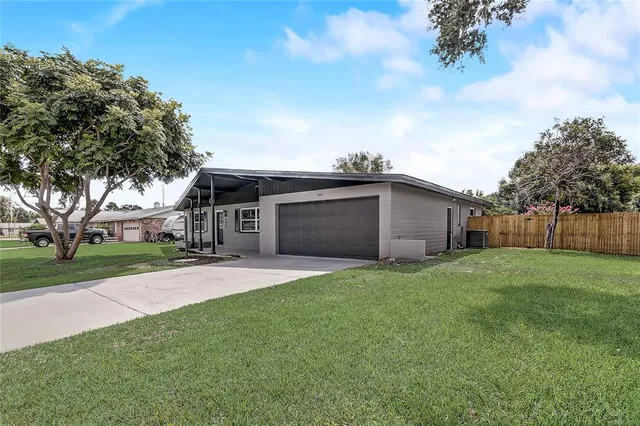a view of a hallway with wooden floor and windows