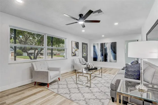 a kitchen with stainless steel appliances kitchen island granite countertop a refrigerator and a sink