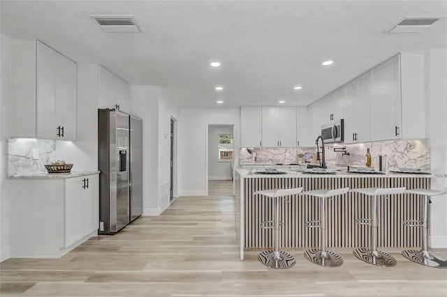 a view of a big room with wooden floor and a window