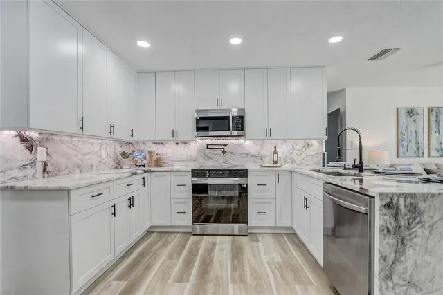 a view of a workspace with furniture and a potted plant