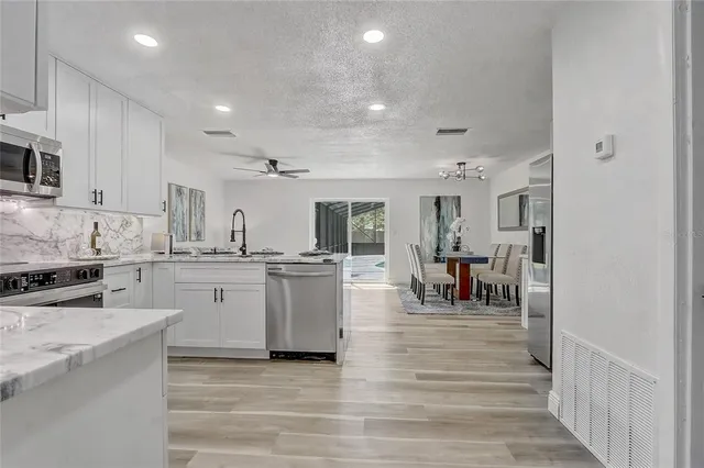 a view of a dining room with furniture and potted plant