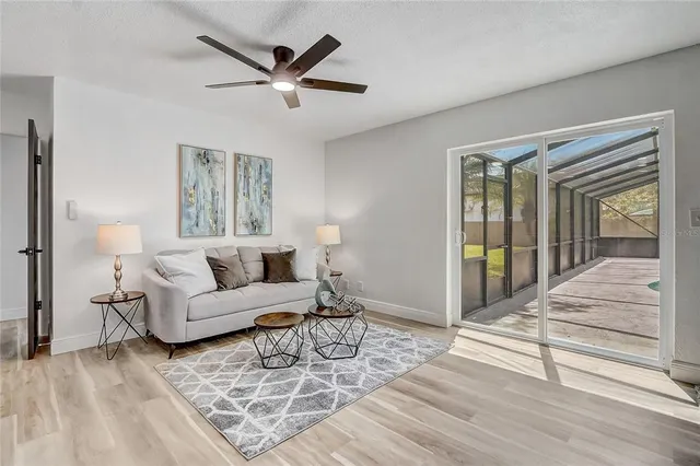 a bedroom with a bed chandelier and a window