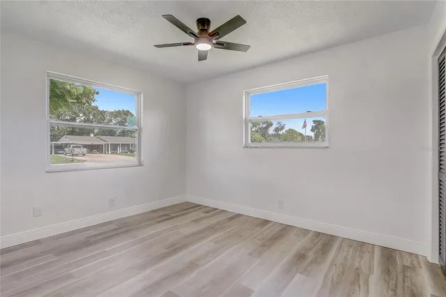 a bathroom with a granite countertop sink a toilet and a large mirror