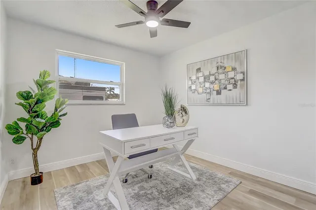 a bathroom with a granite countertop toilet sink and mirror