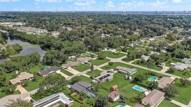 an aerial view of residential houses with outdoor space and lake view