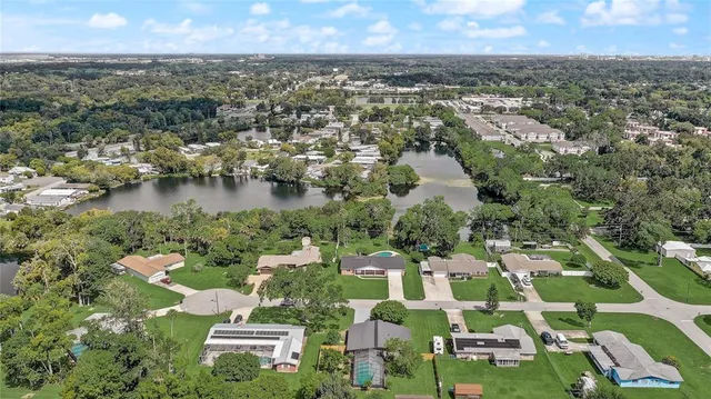 an aerial view of a house with a lake view