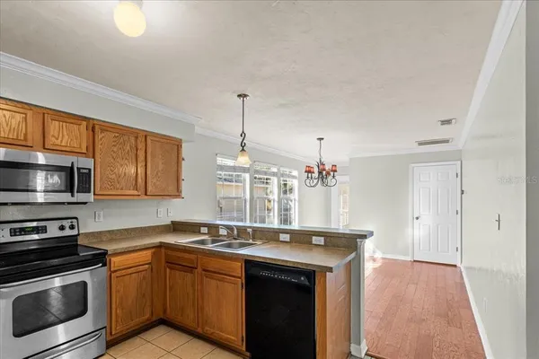 a kitchen with stainless steel appliances granite countertop a sink stove and microwave