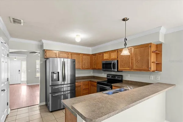 a kitchen with a refrigerator a microwave a sink and a stove