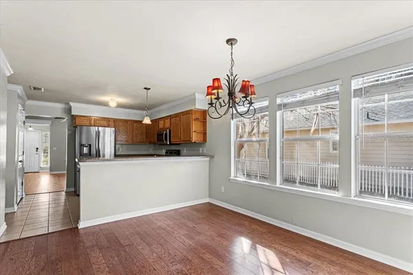 a view of a kitchen with a sink refrigerator and window