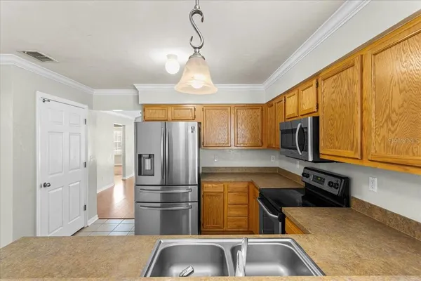 a kitchen with stainless steel appliances granite countertop a refrigerator and a sink