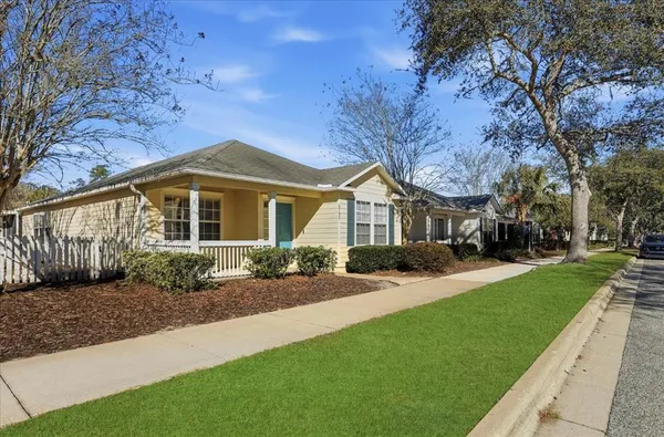 a front view of a house with yard and green space