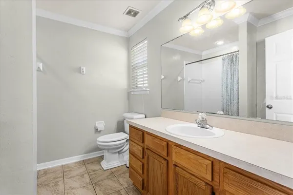 a bathroom with a sink toilet and a mirror
