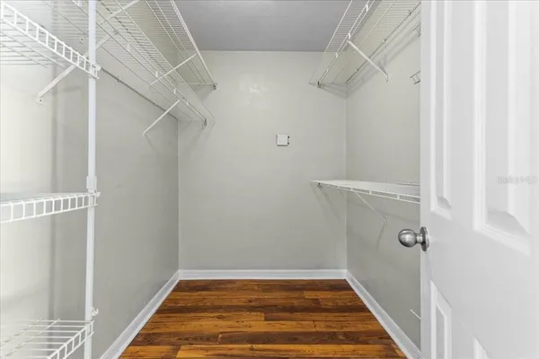 a view of a room with wooden floor
